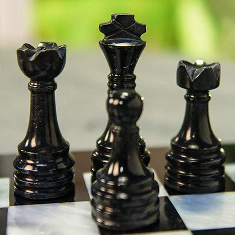 Premium Photo  Three pieces on a dark chessboard